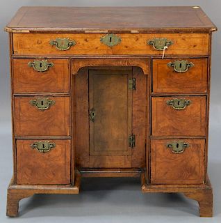 Mid-Georgian carved and veneered walnut knee-hole dressing table, the rectangular quarter-veneered molded top above a case wi