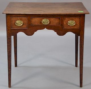 George II oak dressing table with rectangular top and three drawers set on square tapered legs. 
ht. 28in., top: 18" x 29 1/2