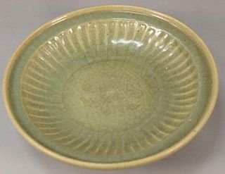 Large Chinese celadon glazed ceramic deep charger with incised flower center.  ht. 3 1/4in., dia. 13 1/4in.