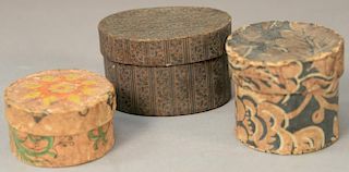 Three small covered wallpaper boxes to include a round Pennsylvania box pale salmon with orange, yellow, and green; a round b