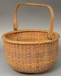 Nantucket lightship basket with swing handle having original paper label on bottom marked Lightship Baskets made by Mitchell 