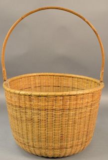 Large Nantucket style basket with swing handle, ship and whales inlaid into wood bottom.
basket ht. 12 1/2in., dia. 17 1/2in.