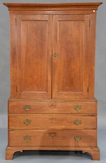 Chippendale cherry cabinet in two parts, upper section with two doors opening to three shelves on base with three drawers on 