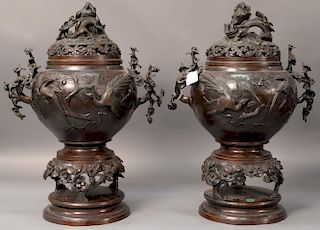 Pair of large bronze censors having dragon finial cover over bulbous body with molded peacock and blossoming tree handles on 