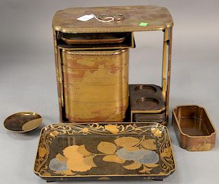 Two Japanese gold lacquered pieces to include a portable luncheon box having four part stacking trays having Y. Tsuruki deale