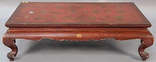 Chinese red lacquer gilt decorated low table, 20th century (extensive losses, especially at base of feet). 
ht. 12 1/2in., wd