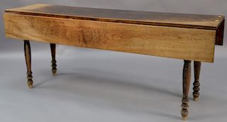 Sheraton harvest table set on turned legs, circa 1820-1830.  ht. 29in., top closed: 18" x 72", top open: 36" x 72" Provenance