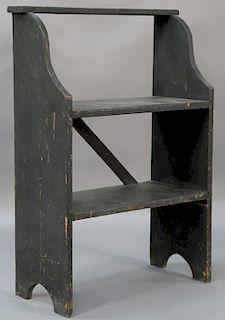 Black painted bucket bench having small shelf over two large shelves on boot jack ends.  ht. 39in., wd. 26in., dp. 11 3/4in. 