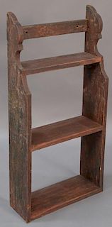 Primitive hanging shelf retaining some original red paint.  ht. 35 1/2in., wd. 17in. Provenance:  Estate of Arthur C. Pinto, 