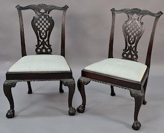 Pair of Chippendale mahogany side chairs having carved crest rail, open work back, and slip seat, all set on carved cabriole 