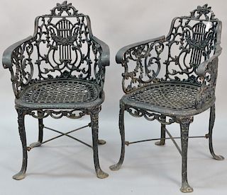 Pair of Victorian iron chairs with lyre type backs. 
ht. 32in., wd. 21 1/4in.