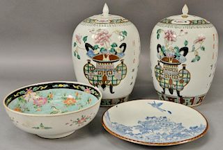 Four Chinese porcelain pieces to include a Famille Rose bowl, blue and white charger, and pair of porcelain ginger jars with 