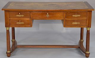 French Empire desk with tooled leather top and five drawers on turned legs with bronze capitals, 19th century (top stained). 