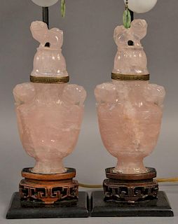 Pair of Chinese carved pink quartz urns with foo dog tops, now made into table lamps.
urn ht. 8 1/4in.
total ht. 18 1/4in.