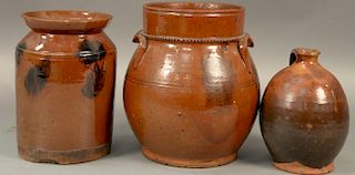 Three piece lot to include two redware crocks with manganese decoration and a redware small jug (minor chips).  crocks: ht. 8