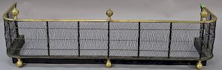 Federal wire fire fender with brass top rail with three finials, set on brass ball feet, circa 1830. 
ht. 15 1/2in., wd. 53in