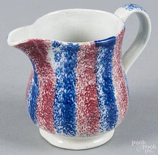 Red and blue rainbow spatter cream pitcher, 19th c., 3 1/2'' h.