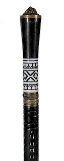 5. Sword Cane- Twentieth Century- Ebony handle with a brass lion atop, manmade substance which is crosshatched above the bras