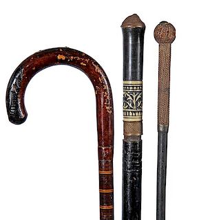 49. Three Weapon Canes- Ca. 1890-1950- This group consists of one sword cane, a small woven handle bludgeon cane and probably