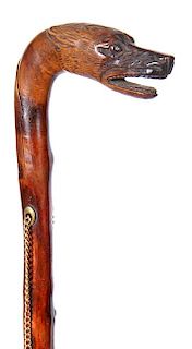 74. Wolf Folk Art Cane- Ca. 1880- A one-piece carved natural branch with a pair of brass eyelets, brass shell ferrule, there 