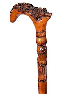 78. Alligator Folk Cane- Ca. 1925- A carved “Jacksonville” gator which is orange tree wood, attached to a nice bamboo sha