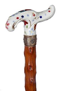 81. Porcelain Dress Cane- Ca. 1890- An art nouveau porcelain handle, an ornate silver metal collar, umbrella shaft and no fer