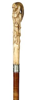 87. Japanese Stag Monkey Cane- Ca. 1890- A carved stag handle with a mother ape about to feed her child, the back side of the