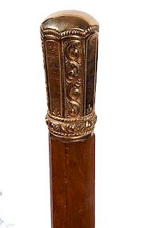 114. Gold Dress Cane- Ca. 1850- An ornate unmarked but tested 14 kt gold handle with exceptional scroll casting, a walnut sha