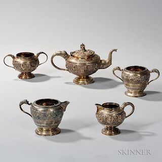 Five Pieces of Indian Silver Tableware, a three-piece tea service, each with elephant-form handles and a central register of 