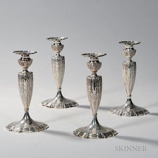 Four Gorham Sterling Silver Candlesticks, Providence, 20th century, each with an urn-form sconce and reeded bobeche on a tape