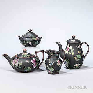Four Wedgwood Enameled Black Basalt Tea Wares, England, 19th century, each polychrome decorated with flowers, a squat form te
