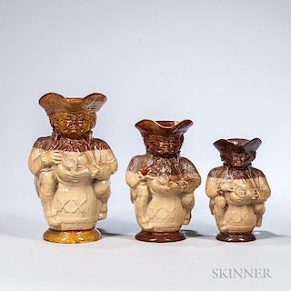 Three Doulton Lambeth Stoneware Toby Jugs, England, late 19th century, each with a partial brown glaze over a buff body, and 