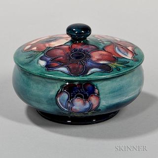 Moorcroft Anemone Box and Cover, England, c. 1960, circular squat shape with button knop, printed Royal Warrant label and imp