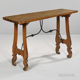 Baroque-style Spanish Walnut Table, 19th century, long rectangular top over carved end supports joined by an iron curvate str