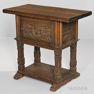 Jacobean-style Oak Writing Cabinet, early 20th century, with a hinged upper surface above the single carved door with portrai