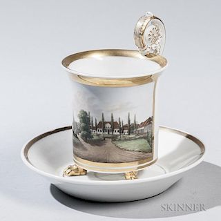 KPM Topographic Porcelain Cup and a Saucer, Germany, 20th century, white ground with gilding, cylindrical body decorated with