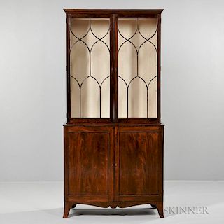 George III-style Mahogany Cupboard Bookcase, England, 19th century, cornice projection over two glass doors with Gothic-style