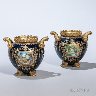 Pair of English Porcelain Landscape Vases, 19th century, each with overall gilding and a pierced fan-motif rim over a cobalt 