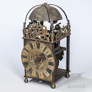 English Lantern Clock, 19th century, in the 18th century style, domed top over pierced frieze, roman numeral dial, on turned 
