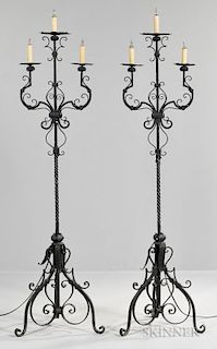 Pair of Renaissance-style Wrought Iron Torchieres, 20th century, each with three-light armature joining a twisted support, re