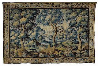 Flemish Verdure Tapestry, 18th century, depicting a landscape with lush foliage and architectural scene in the distance, with