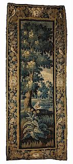 Flemish Verdure Tapestry Fragment, 18th century, with heavy foliage and a bird, castle-like building in the distance, border 
