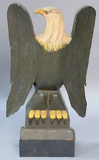 Large primitive carved and painted eagle perched on stand. <R>ht. 27in., wd. 15 1/2in.<R>Provenance: Estate of Arthur C. Pint