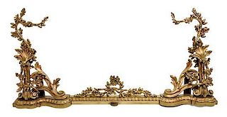 A Louis XV Style Gilt Bronze Fireplace Suite Height of chenets 21 inches.