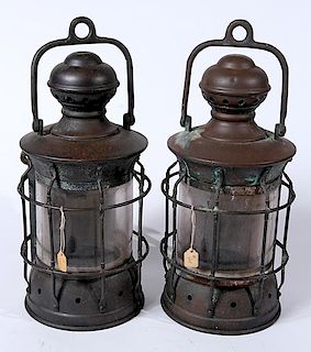 A pair of nautical brass lanterns with protection brackets which have been electrified, original handles and brackets