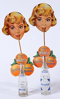 A pair of cardboard and wood Whistle advertising bottle toppers 15" length