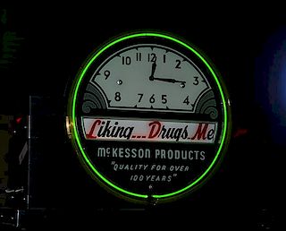 Drug store Neon clock with scrolling paper sign, 10" x 20" x 27", two bands of neon of which the green is working, scrolling 