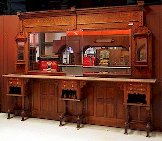 Victorian oak barbershop back bar, w-11' x h-7' 9" x d-14", pinkish brown marble top with glass drawer pulls, beveled mirrors