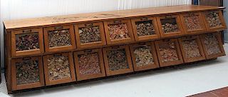 Oak seed cabinet, iron pulls on doors are signed Walker Bin Company, cabinet has 16 drawers with all original pulls, 10' long