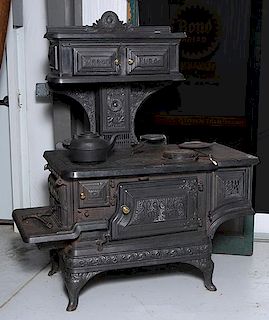 Magee Restored wood cook stove, Near mint, fancy decoration and brass pulls, 57" x 30"x 69"